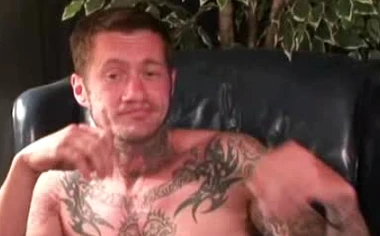 Seductive tattooed hunk jerks off while moaning in hot solo